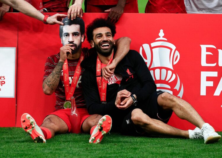 Klopp says Salah is OK after coming off in Cup final 1 - Egyptian Gazette Liverpool’s Thiago Alcantara (L) celebrates winning the FA Cup by wearing a mask of Mohamed Salah next to the man himself.