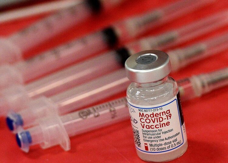 Syringes and a vial of the Moderna COVID-19 vaccine are displayed at a mass COVID-19 vaccination site in Batavia.