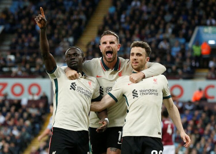 Soccer Football - Premier League - Aston Villa v Liverpool, Villa Park, Birmingham, Britain - May 10, 2022 Liverpool's Sadio Mane celebrates scoring their second goal with Diogo Jota and Jordan Henderson REUTERS/Craig Brough EDITORIAL USE ONLY. No use with unauthorized audio, video, data, fixture lists, club/league logos or 'live' services. Online in-match use limited to 75 images, no video emulation. No use in betting, games or single club /league/player publications.  Please contact your account representative for further details.     TPX IMAGES OF THE DAY