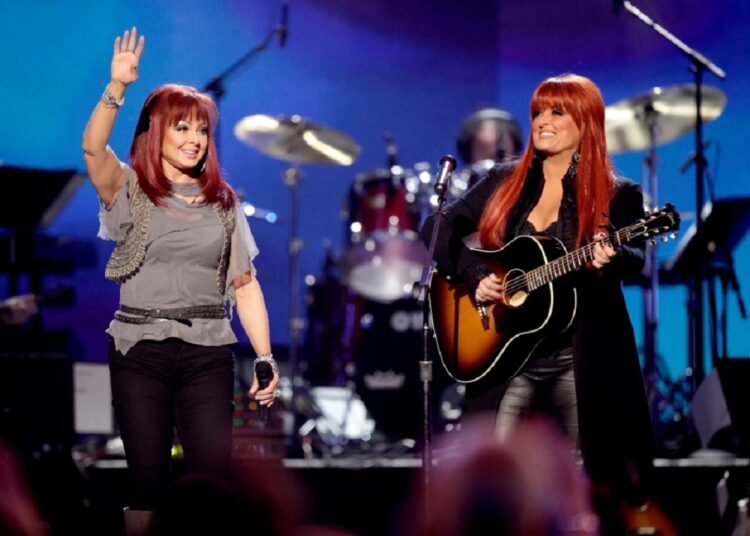 FILE - Naomi Judd, left, and Wynonna Judd, of The Judds, perform at the "Girls' Night Out: Superstar Women of Country," in Las Vegas, April 4, 2011.