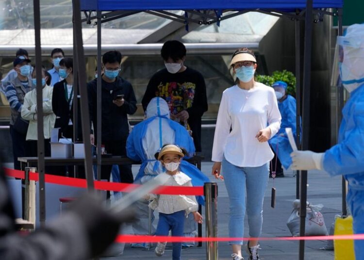 Residents line up for mass COVID-19 testing in Beijing. China has stuck to its strict "zero-COVID" approach that restricts travel, mass tests entire cities and sets up sprawling temporary facilities to try to isolate every infected person.
