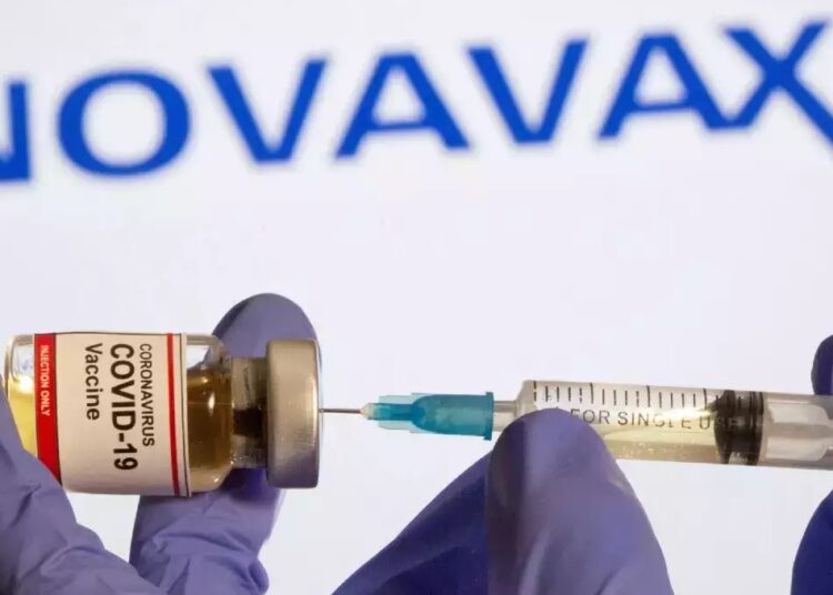 Novavax 2022 COVID vaccine deliveries off to slow start 1 - Egyptian Gazette A vial and syringe are seen in front of a displayed Novavax logo in this illustration taken January 11, 2021.