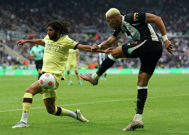 Arsenal's Mohamed Elneny (L) and Newcastle United's Joelinton in action during their English Premier League match at St. James' Park, Newcastle.