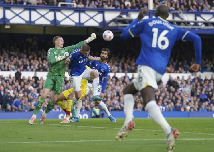 Everton's goalkeeper Jordan Pickford taps the ball away during their English Premier League match against Crystal Palace in Liverpool.