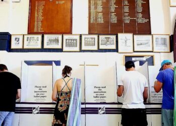 Australian voters head to polls in close-run election