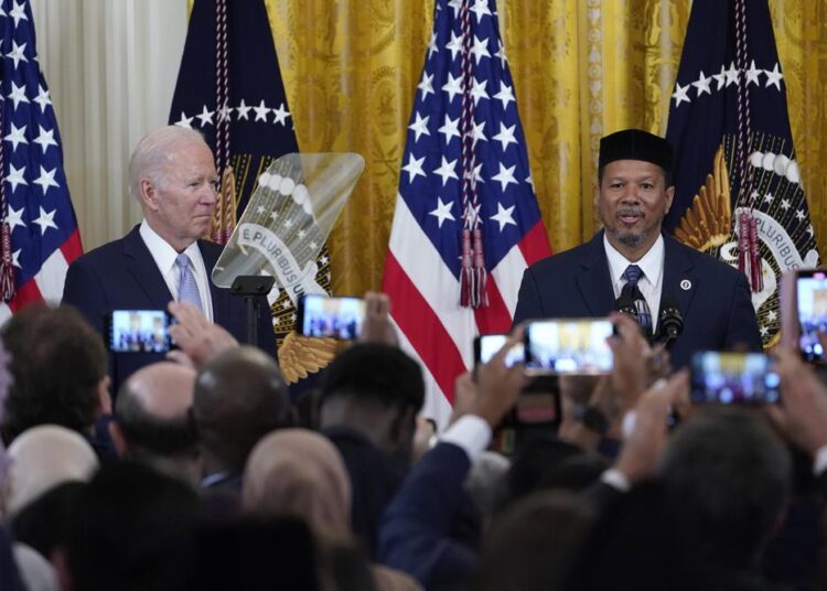 President Joe Biden (L) listens as Talib M. Shareef President and Imam of the historic, Nation's Mosque, Masjid Muhammad in Washington, speaks during a reception to celebrate Eid al-Fitr in the East Room of the White House in Washington, on Monday, May 2, 2022.
