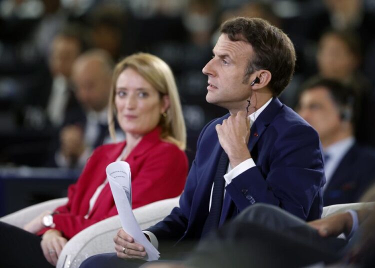 Macron proposes new political union for non-EU countries 1 - Egyptian Gazette French president Emmanuel Macron removes his earpiece as European Parliament President Roberta Metsola looks at him, during the Conference on the Future of Europe, in Strasbourg, eastern France, Monday, May 9, 2022. Macron traveled to Strasbourg on Monday as the final report on the Conference of Europe was set to be presented by EU institutions leaders. France currently holds the six-month rotating presidency of the Council of the EU.