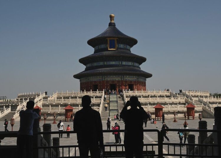 Beijing tourist sites empty in Covid-stalked public holiday 1 - Egyptian Gazette People walk inside the Temple of Heaven in Beijing during the Labour Day holidays on May 2, 2022. (Photo by Noel Celis / AFP)
