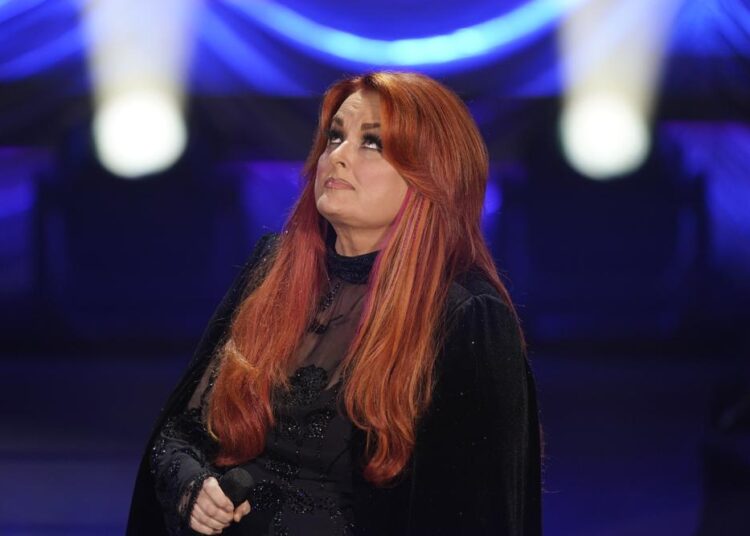 Wynonna Judd looks up after singing during a tribute to her mother, country music star Naomi Judd, Sunday, May 15, 2022, in Nashville, Tenn. Naomi Judd died April 30. She was 76.