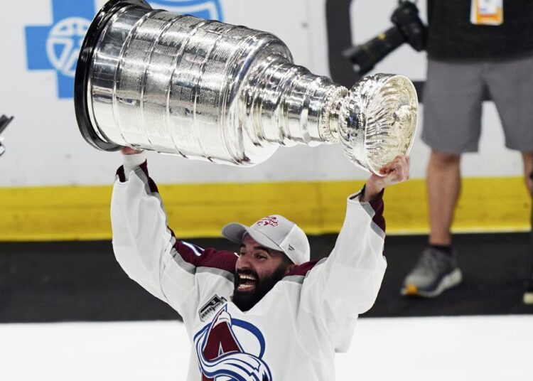 Colorado Avalanche center Nazem Kadri lifts the Stanley Cup after the team defeated the Tampa Bay Lightning 2-1 in Game 6 of the NHL hockey Stanley Cup Finals on Sunday, June 26, 2022, in Tampa, Fla.