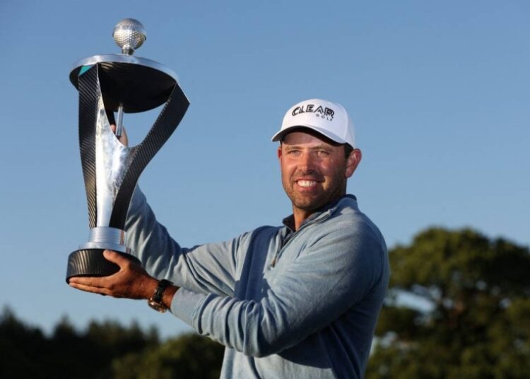 South Africa's Charl Schwartzel poses with the trophy after winning the LIV Golf Invitational Series.