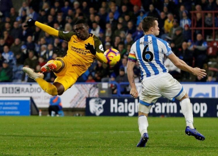 Brighton’s Yves Bissouma shoots at goal as Huddersfield Town’s Jonathan Hogg attempts to block, in John Smith’s Stadium, Huddersfield.