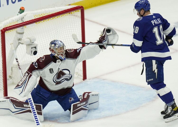 Colorado Avalanche goaltender Darcy Kuemper makes a save on a shot from Tampa Bay Lightning Ondrej Palat during Game 3 of an NHL Stanley Cup Final.