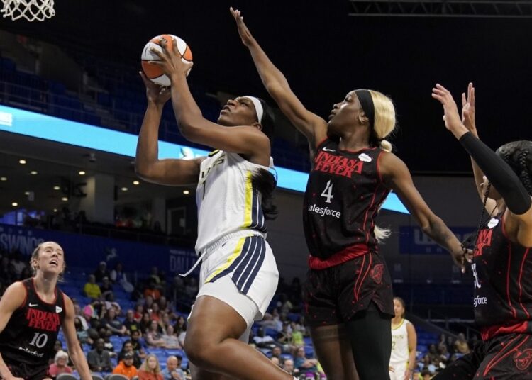 Dallas Wings Teaira McCowan goes up for a shot as Indiana Fever's Lexie Hull (10), Queen Egbo (4) and Destanni Henderson (R) defend during their WNBA basketball game in Arlington, Texas.