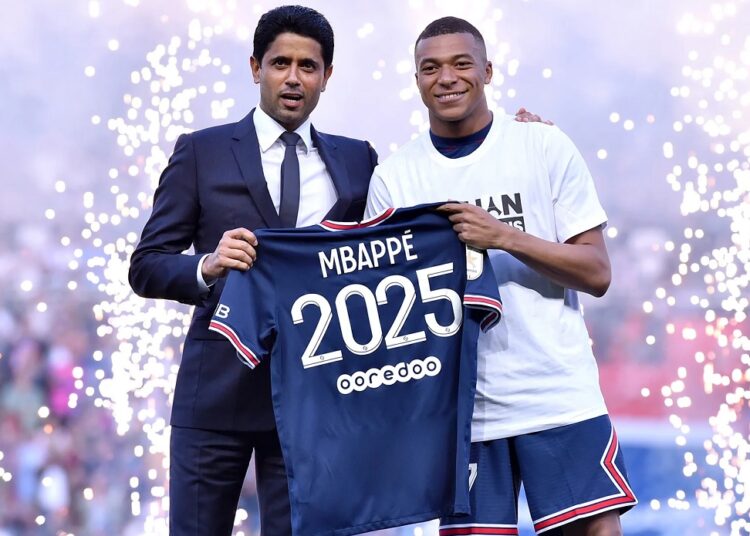 Paris St Germain's Kylian Mbappe poses for a photo with Paris St Germain president Nasser Al-Khelaifi after signing a new contract.