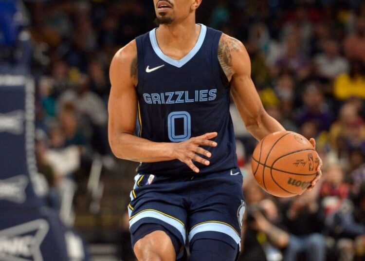 Memphis Grizzlies guard De'Anthony Melton handles the ball during the team's NBA game against the Phoenix Suns on April 1, 2022, in Memphis, Tenn.
