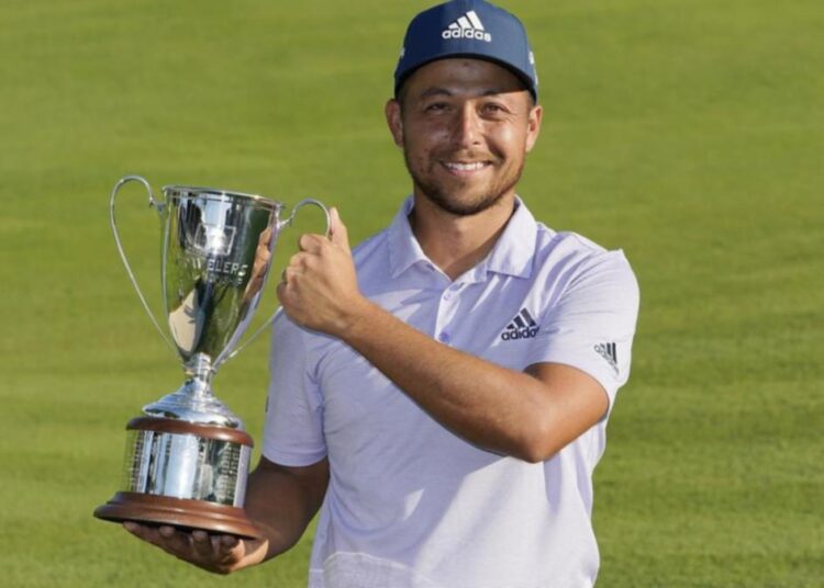 Xander Schauffele holds the trophy after winning the Travelers Championship golf tournament in Cromwell.