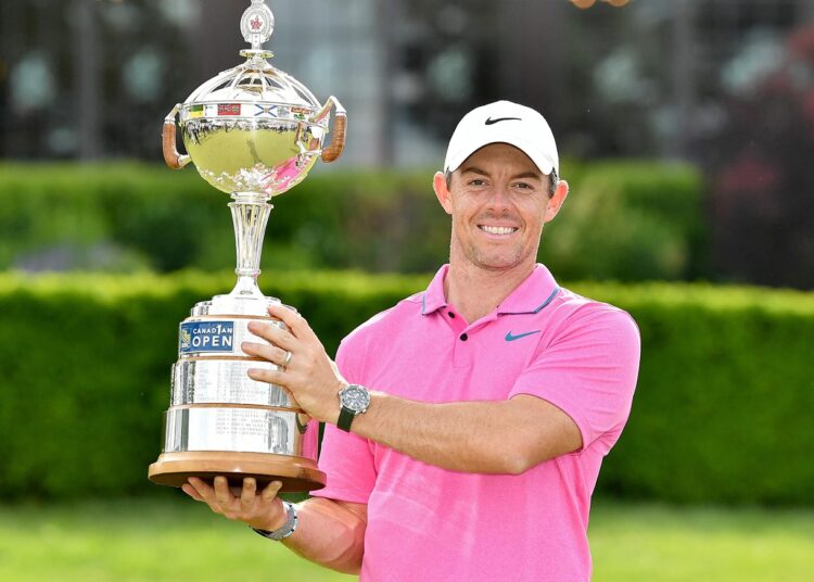 Rory McIlroy posing with the trophy after winning the RBC Canadian Open.