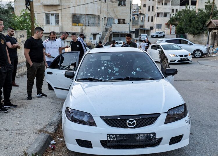 3 Palestinians killed by Israeli force in Jenin 1 - Egyptian Gazette Locals inspect the bullet-riddled vehicle where three armed Palestinians were killed by Israeli soldiers on June 17, 2022.