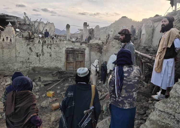 Afghans look at destruction caused by an earthquake in the province of Paktika, eastern Afghanistan, on Wednesday, June 22, 2022.