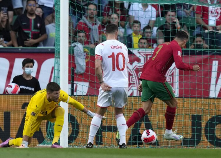 Portugal's Cristiano Ronaldo (R) scores his side's third goal during the UEFA Nations League against Switzerland in Lisbon, Portugal.