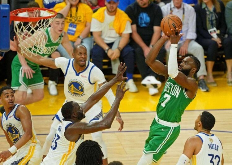 Boston Celtics Jaylen Brown (R) shoots the ball against the Golden State Warriors during game one of the 2022 NBA Finals in California.