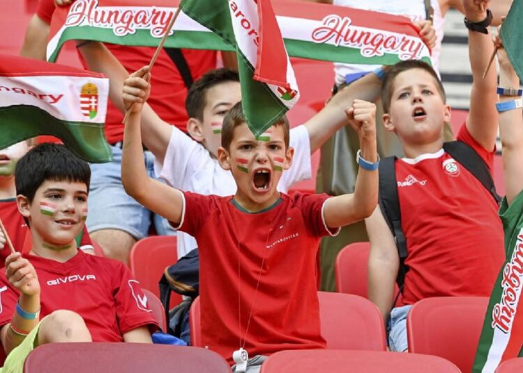 Schoolchildren under the age of 14 cheer in the tribune during the UEFA Nations League match between Hungary and England in Budapest, Hungary.