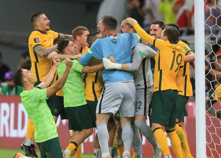 Australian players celebrate after winning in a penalty shoot-out during the World Cup 2022 qualifying play-off match against Peru in Al-Rayyan, Qatar.