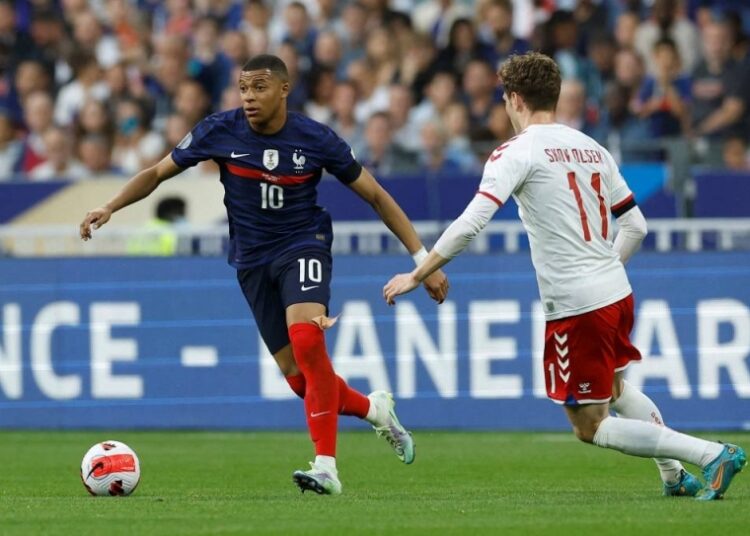 France's Kylian Mbappe in action with Denmark's Andreas Skov Olsen at Stade de France, Saint-Denis June 3, 2022.