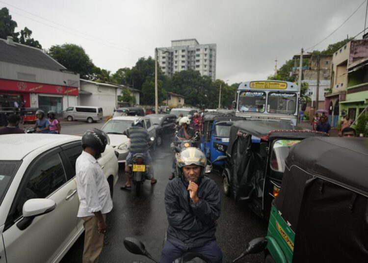 Sri Lanka PM says economy ‘has collapsed,’ unable to buy oil 1 - Egyptian Gazette Scooterists and motorists wait in long queues at a fuel station in in Colombo, Sri Lanka, Saturday, June 11, 2022.