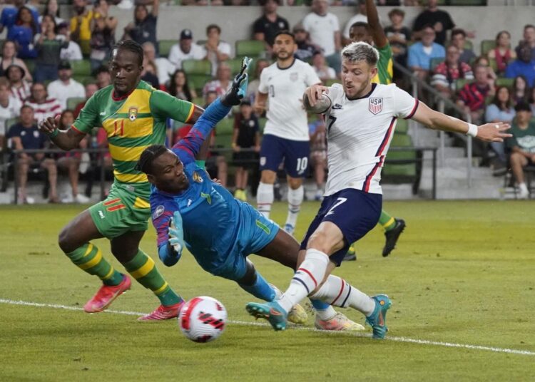 US forward Paul Arriola (7) shoots past Grenada goalkeeper Jason Belfon (1) and midfielder Shavon John-Brown (11) for a goal during the second half of a CONCACAF Nations League soccer match in Austin, Texas.