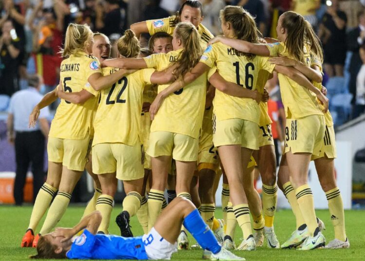 Belgium into Women's Euro quarters 1 - Egyptian Gazette Italy's Valentina Giacinti sits on the ground while Belgium players celebrate in the background at the end of their Women Euro 2022 match.