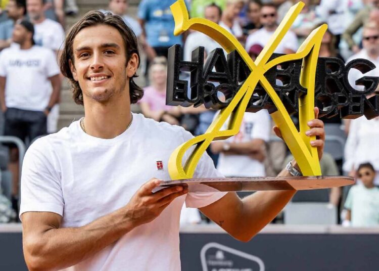 Lorenzo Musetti poses with trophy after winning the men's singles final against Carlos Alcaraz at the Hamburg Open.