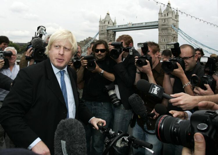 FILE - Britain Conservative Party MP, Boris Johnson, left, speaks to the media to launch his campaign as a candidate to be the Mayor of London, outside City Hall in central London, Monday, July 16, 2007. British media say Prime Minister Boris Johnson has agreed to resign on Thursday, ending an unprecedented political crisis over his future.