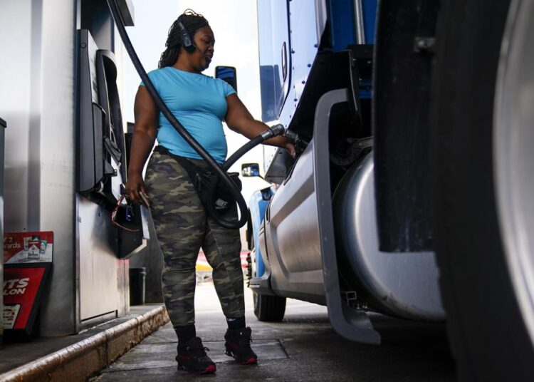 Wholesale inflation in June surged 11.3% from a year ago 1 - Egyptian Gazette Delores Bledsoe, of Houston, Texas, fuels up her rig at a truck stop in Carlisle, Pa., Wednesday.
