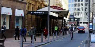 New Zealand announces free masks, tests as health system struggles with Covid