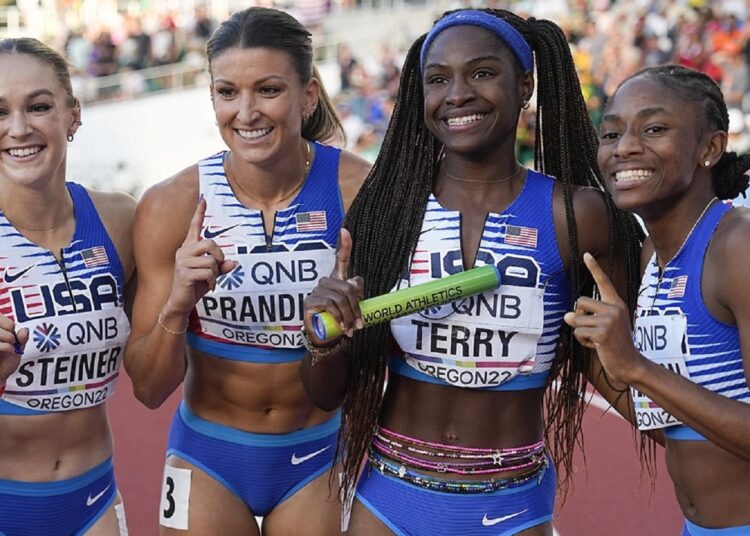 US runners pose after winning the women’s 4x100m relay final at the World Athletics Championships.