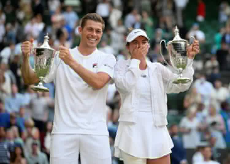 Desirae Krawczyk and Britian's pose for a photograph with their trophies as they celebrate winning the mixed doubles final in London.
