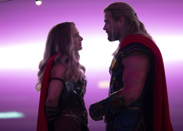 This image released by Marvel Studios shows Natalie Portman, left, and Chris Hemsworth in a scene from "Thor: Love and Thunder."