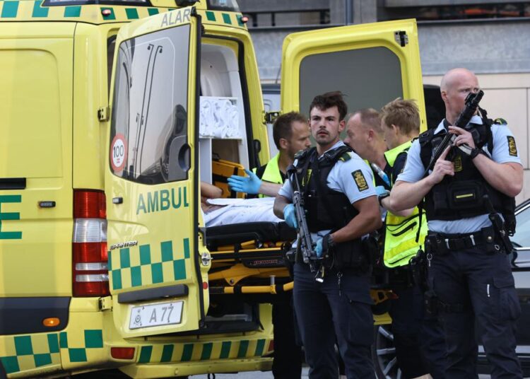 An ambulance and armed police outside the Field's shopping center, in Orestad, Copenhagen, Denmark, Sunday, July 3, 2022, after reports of shots fired. Danish police say several people have been shot at a Copenhagen shopping mall. Copenhagen police said that one person has been arrested in connection with the shooting at the Field’s shopping mall on Sunday. Police tweeted that “several people have been hit” but gave no other details.