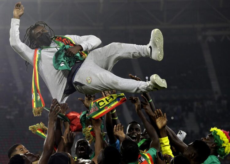 FILE - Senegal's players celebrate with Senegal's head coach Aliou Cisse after winning the African Cup of Nations 2022 final soccer match between Senegal and Egypt at the Ahmadou Ahidjo stadium in Yaounde, Cameroon, on Feb. 6, 2022. The next African Cup of Nations will again clash with the European season and likely give rise to more club vs. country friction and disgruntlement over the release of players after organizers decided to postpone it until January 2024. The decision was announced Sunday, July 3, 2022, by the Confederation of African Football.