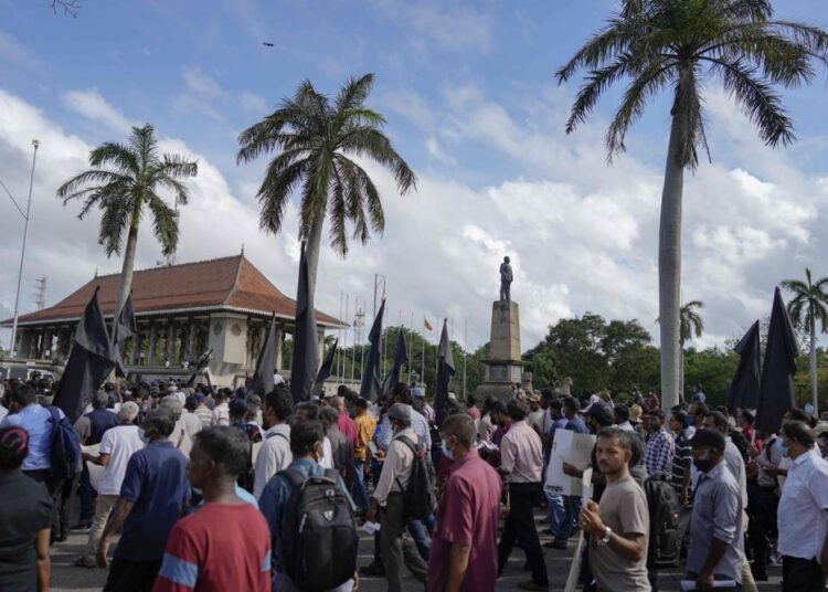 Trade union and civil society activists led by leftists' People Liberation Front shout slogans denouncing president Ranil Wickremesinghe in Colombo, Sri Lanka, Tuesday, August 9, 2022.