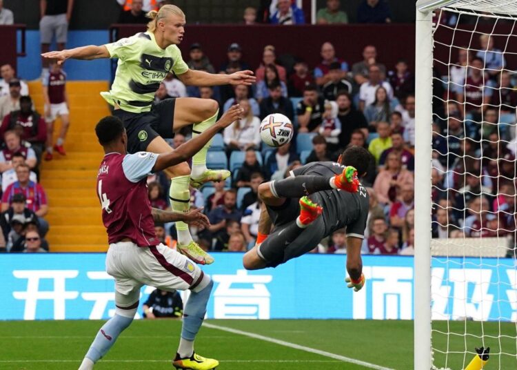 Manchester City's Erling Haaland scores his side's opening goal against Aston Villa in Birmingham.