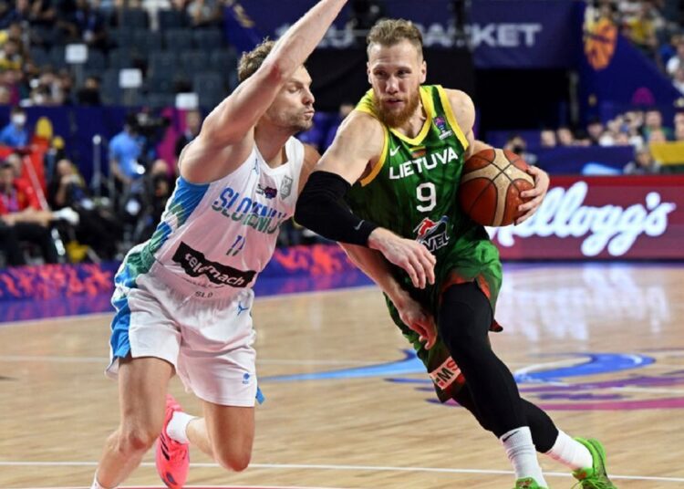Slovenia's Jaka Blazic (L) defends Lithuania's Ignas Brazdeikis during the EuroBasket group B match in Cologne, Germany.