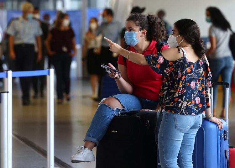 A file photo showing passengers wear protective masks after the outbreak of the coronavirus disease (COVID-19) at the airport in Frankfurt, Germany, August 11, 2020.