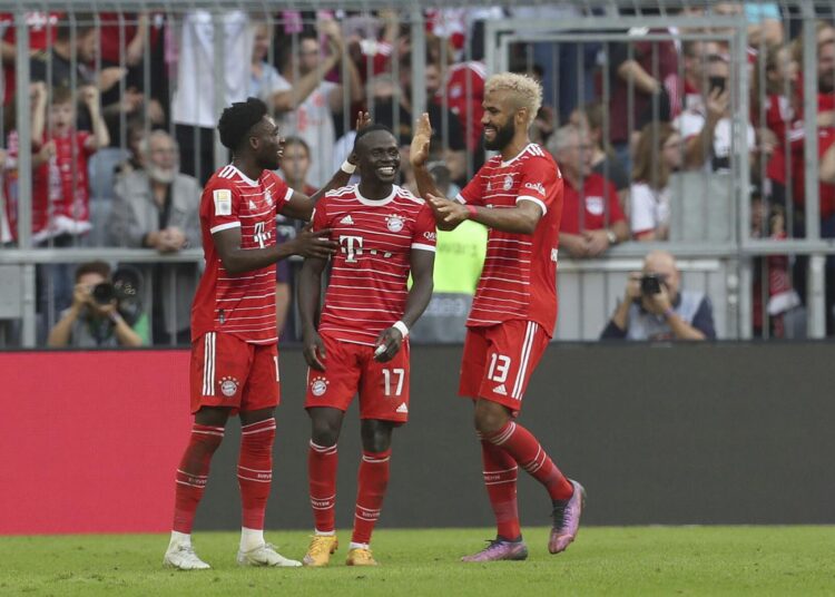 Bayern's Sadio Mane (C) celebrates with teammates Alphonso Davies (L) and Eric Maxim Choupo-Moting, after scoring his side’s third goal against Mainz.