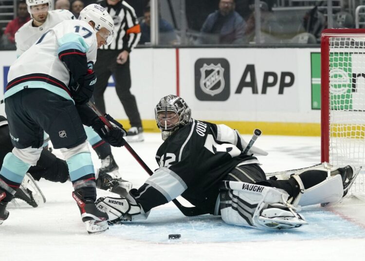 Seattle Kraken Jaden Schwartz (L) gets ready to score on Los Angeles Kings goaltender Jonathan Quick during their NHL hockey game in Los Angeles.