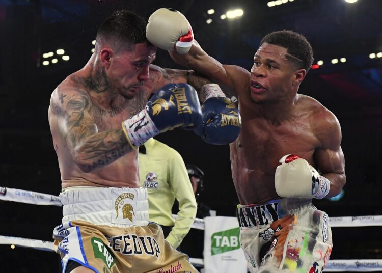 Devin Haney of the United States (R) punches George Kambosos Jr. of Australia during their world lightweight title boxing match between in Melbourne, June 5, 2022.
