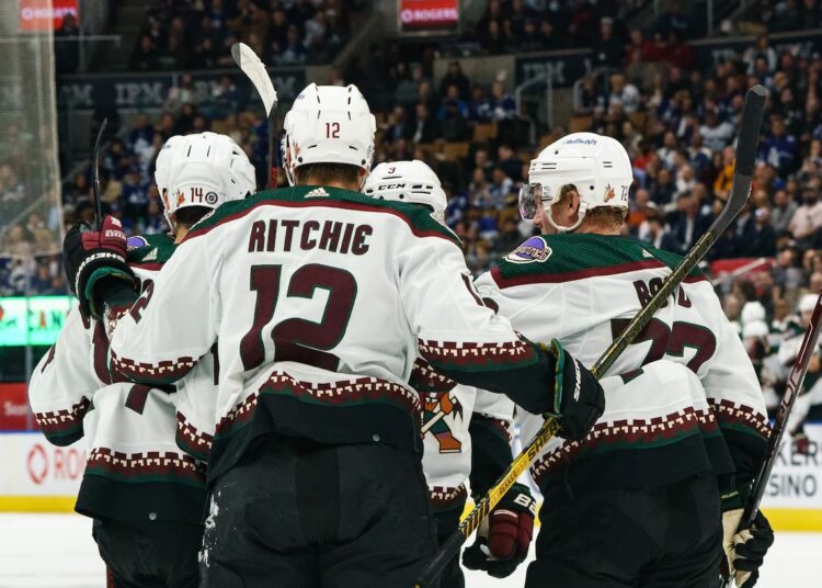 Arizona Coyotes’ players celebrate after scoring a powerplay goal during first-period NHL game action against Toronto Maple Leafs in Toronto.