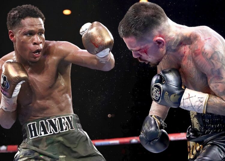 Devin Haney (L) lands a hook on George Kambosos during their bout for undisputed lightweight world boxing champion in Melbourne.